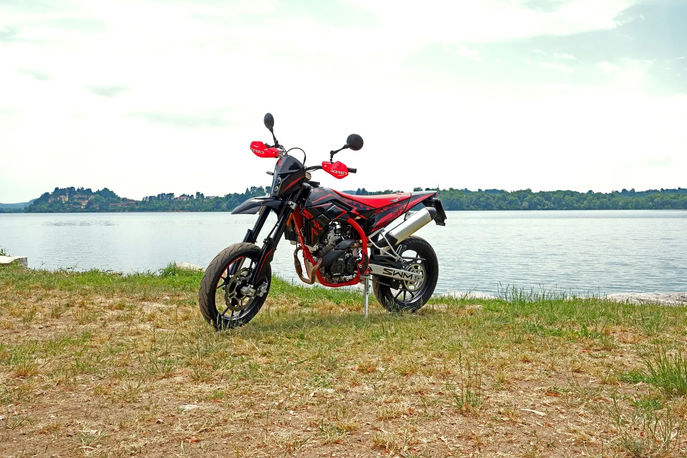 SWM supermoto motorcycle parked by a lake